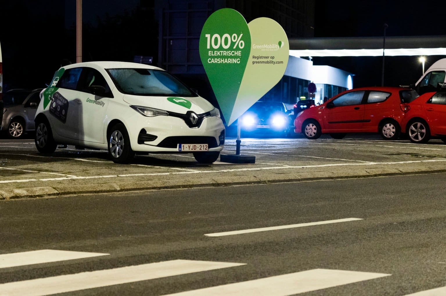 GreenMobility car at night with a big green heart